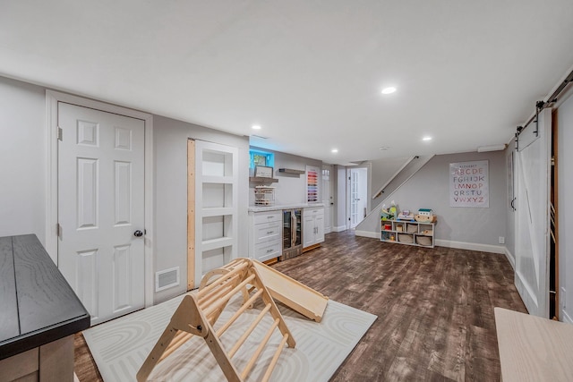 8 Bridle Path Rd, Smithtown, NY 11787 - game room featuring wine cooler, wood finished floors, a barn door, recessed lighting, and baseboards