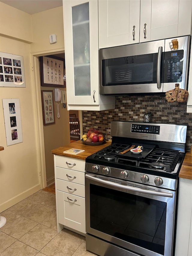 110-20 71st Ave Unit 411, Forest Hills, NY 11375 - kitchen featuring appliances with stainless steel finishes, wood counters, and decorative backsplash