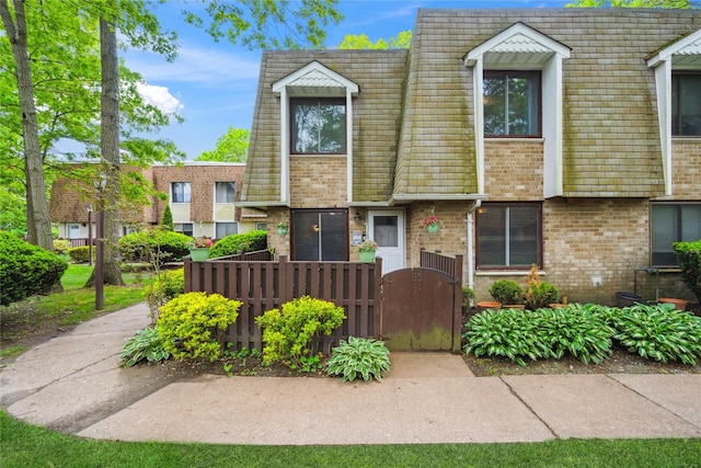 65 Sagamore Hills Dr, Port Jefferson Station, NY 11776 - multi unit property featuring a gate, mansard roof, and brick siding