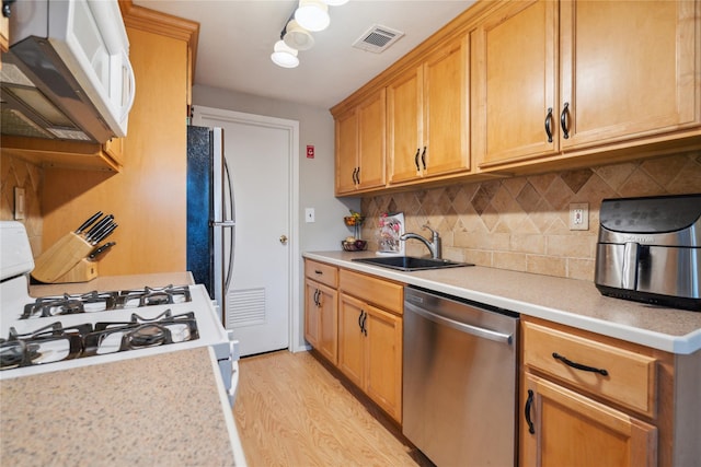 65 Sagamore Hills Dr, Port Jefferson Station, NY 11776 - kitchen featuring appliances with stainless steel finishes, a sink, light wood finished floors, and light countertops