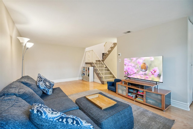 65 Sagamore Hills Dr, Port Jefferson Station, NY 11776 - living room featuring stairway, wood finished floors, and baseboards
