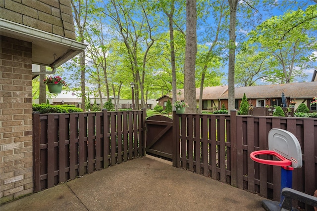 65 Sagamore Hills Dr, Port Jefferson Station, NY 11776 - view of patio featuring a gate and a residential view