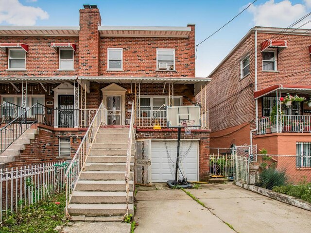 3333 Tiemann Ave, Bronx, NY 10469 - townhome / multi-family property featuring driveway, a garage, brick siding, a chimney, and stairs