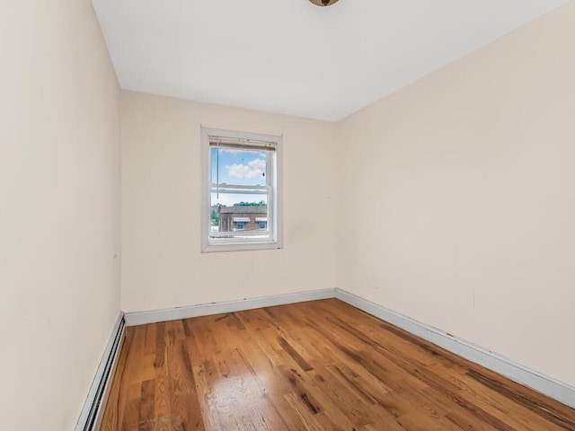 3333 Tiemann Ave, Bronx, NY 10469 - unfurnished room with a baseboard radiator, wood finished floors, and baseboards