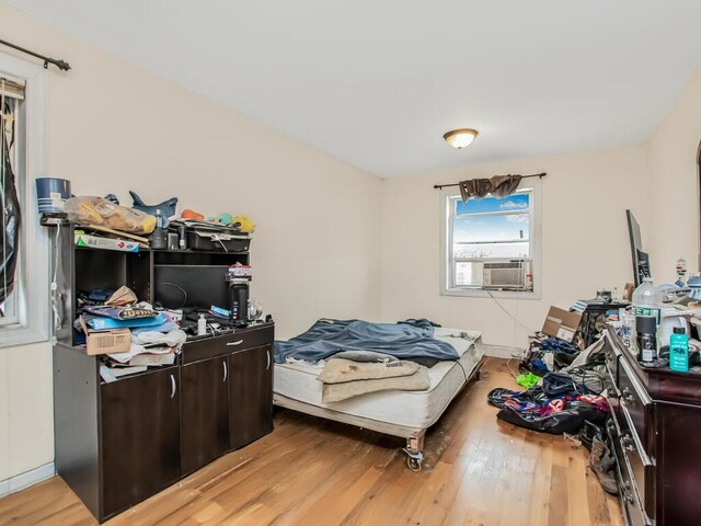 3333 Tiemann Ave, Bronx, NY 10469 - bedroom with wood finished floors and cooling unit