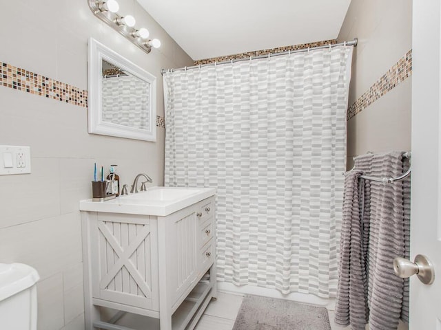 3333 Tiemann Ave, Bronx, NY 10469 - bathroom with vanity, tile walls, toilet, and a shower with shower curtain