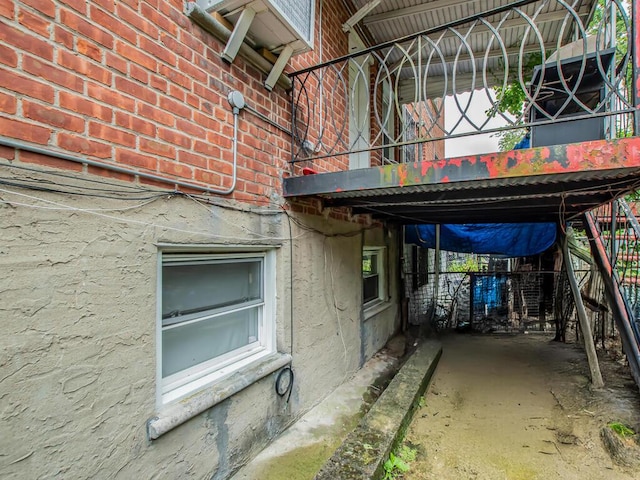 3333 Tiemann Ave, Bronx, NY 10469 - view of property exterior with brick siding, a balcony, and stairway