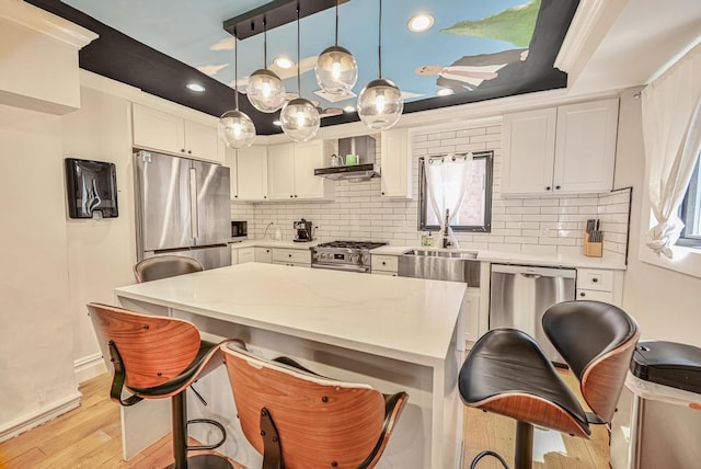 520 Meeker Ave, Brooklyn, NY 11222 - kitchen featuring appliances with stainless steel finishes, wall chimney range hood, light wood-style flooring, light countertops, and recessed lighting