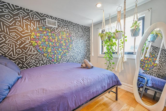 520 Meeker Ave, Brooklyn, NY 11222 - bedroom with wood finished floors, baseboards, and an accent wall