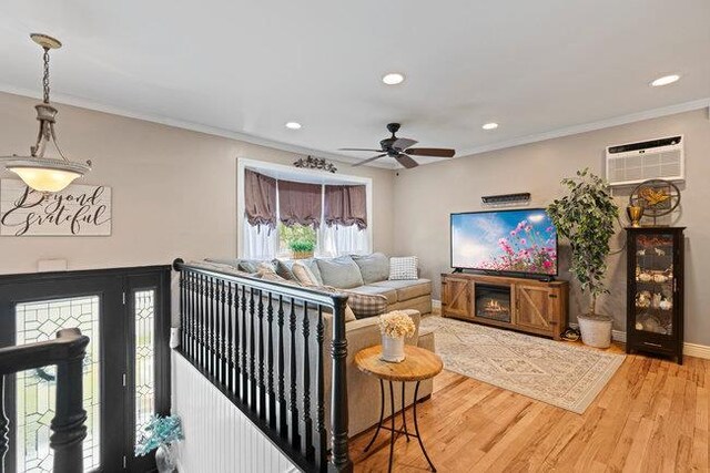105 Fountain Ave, Selden, NY 11784 - living area with ornamental molding, a wall mounted AC, ceiling fan, recessed lighting, and wood finished floors