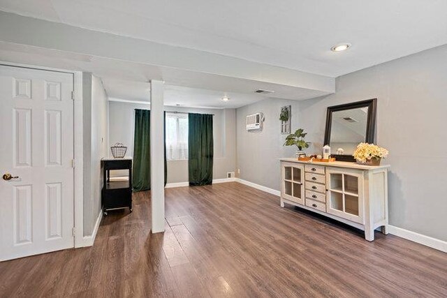 105 Fountain Ave, Selden, NY 11784 - spare room featuring baseboards, dark wood-style flooring, a wall unit AC, and recessed lighting