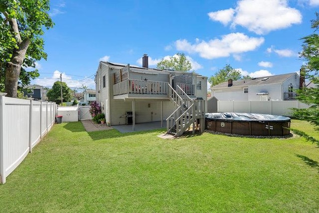 105 Fountain Ave, Selden, NY 11784 - rear view of house with stairs, a deck, a chimney, and a patio area