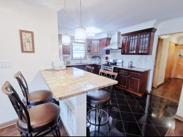 35-73 167th St, Flushing, NY 11358 - kitchen featuring wall chimney range hood, a breakfast bar, ornamental molding, a peninsula, and gas stove