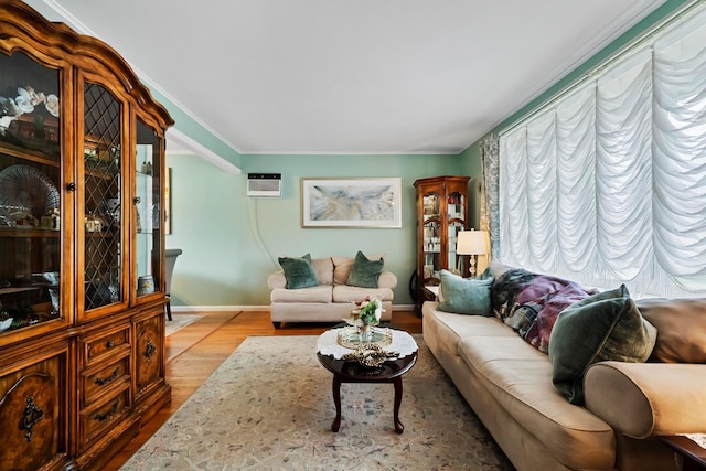 9 Duke St, North Babylon, NY 11703 - living area featuring wood finished floors, baseboards, crown molding, and an AC wall unit