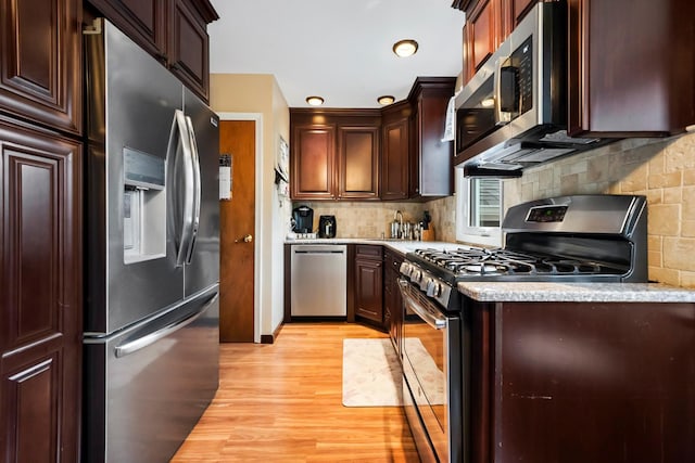 9 Duke St, North Babylon, NY 11703 - kitchen featuring appliances with stainless steel finishes, light wood finished floors, backsplash, light countertops, and a sink