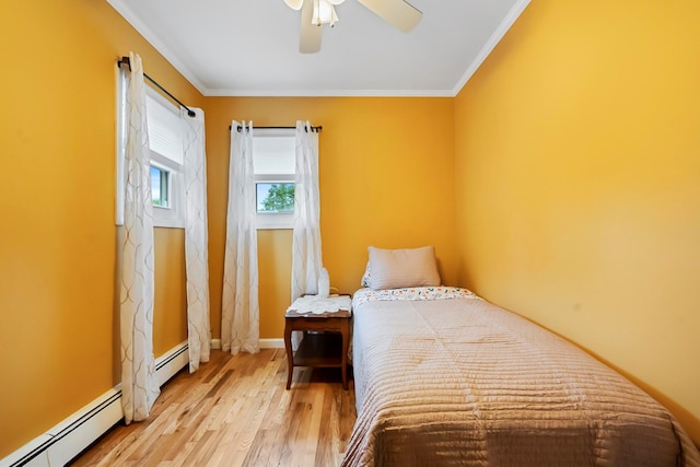 9 Duke St, North Babylon, NY 11703 - bedroom with wood finished floors, a baseboard radiator, ornamental molding, baseboards, and ceiling fan