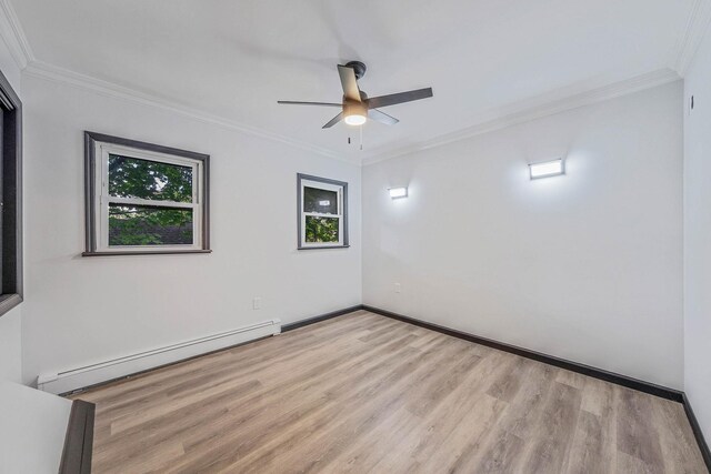 1 William St, Glen Cove, NY 11542 - unfurnished room featuring a baseboard radiator, wood finished floors, a ceiling fan, ornamental molding, and baseboards