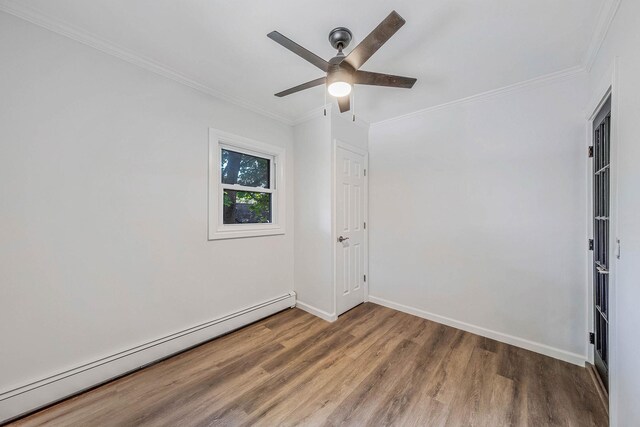 1 William St, Glen Cove, NY 11542 - empty room with a baseboard radiator, wood finished floors, ornamental molding, baseboards, and a ceiling fan