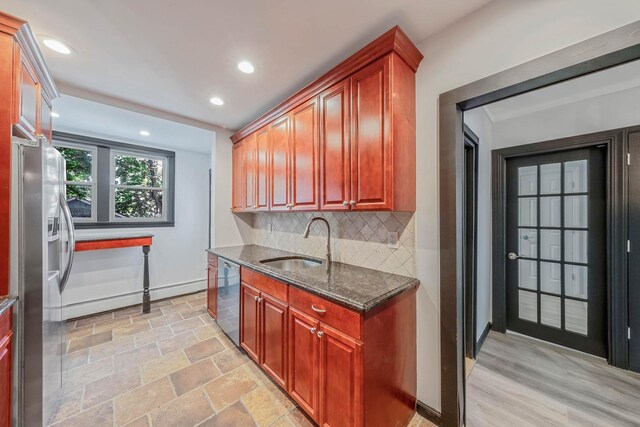 1 William St, Glen Cove, NY 11542 - kitchen with appliances with stainless steel finishes, a sink, decorative backsplash, dark stone counters, and baseboards