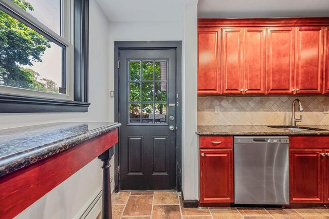 1 William St, Glen Cove, NY 11542 - kitchen featuring stainless steel dishwasher, a sink, decorative backsplash, reddish brown cabinets, and dark stone countertops
