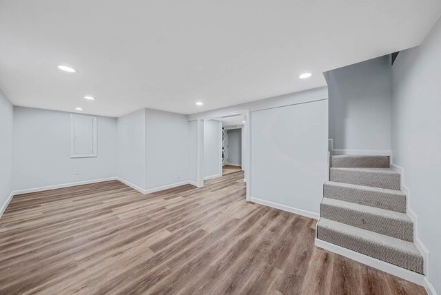 1 William St, Glen Cove, NY 11542 - finished below grade area featuring wood finished floors, baseboards, recessed lighting, and stairway