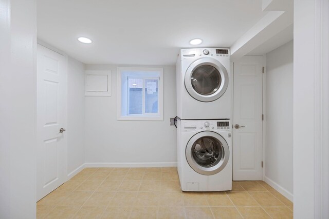 1 William St, Glen Cove, NY 11542 - laundry room with estacked washer and dryer, baseboards, recessed lighting, and light tile patterned floors