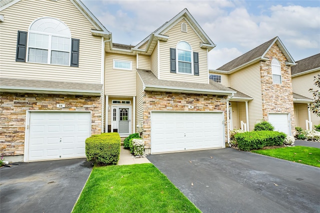 86 Manitou Trl, Kings Park, NY 11754 - multi unit property with a garage, asphalt driveway, stone siding, and a shingled roof