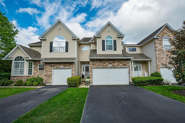 86 Manitou Trl, Kings Park, NY 11754 - view of front of property featuring driveway, an attached garage, stone siding, and roof with shingles