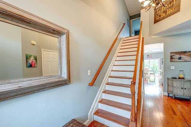 86 Manitou Trl, Kings Park, NY 11754 - stairway with hardwood / wood-style flooring, a chandelier, and baseboards