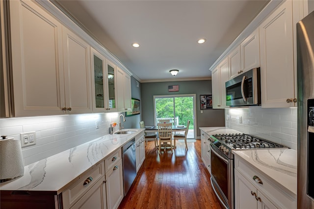 86 Manitou Trl, Kings Park, NY 11754 - kitchen featuring stainless steel appliances, a sink, dark wood-type flooring, white cabinetry, and ornamental molding