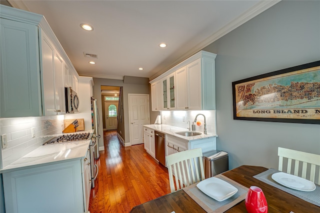 86 Manitou Trl, Kings Park, NY 11754 - kitchen with a sink, appliances with stainless steel finishes, ornamental molding, recessed lighting, and tasteful backsplash