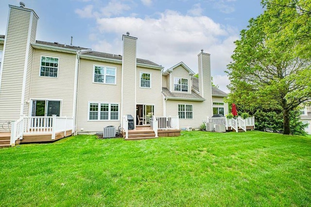 86 Manitou Trl, Kings Park, NY 11754 - rear view of house featuring a deck, a lawn, and central AC unit