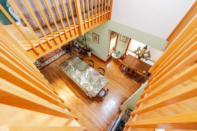 991 W Park Ave, Long Beach, NY 11561 - stairway with wood finished floors, a towering ceiling, and baseboards