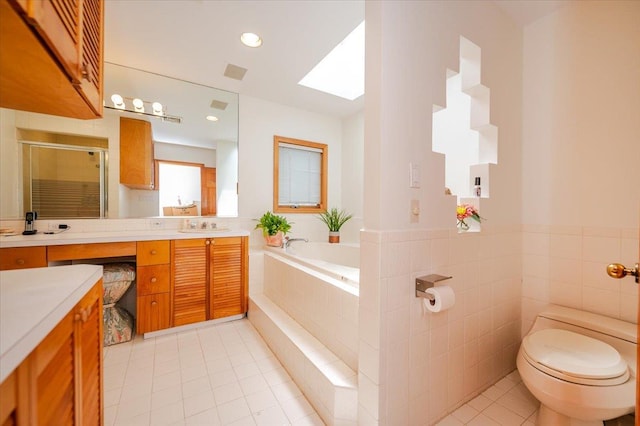 991 W Park Ave, Long Beach, NY 11561 - full bath featuring tile patterned flooring, vanity, a stall shower, a bath, and a skylight