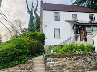 1 Spencer Ct, Hartsdale, NY 10530 - rear view of house featuring stairs and stucco siding