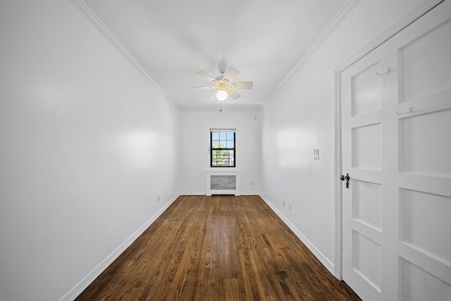 40-40 203rd St Unit 12B, Bayside, NY 11361 - spare room with crown molding, dark wood-style flooring, ceiling fan, and baseboards