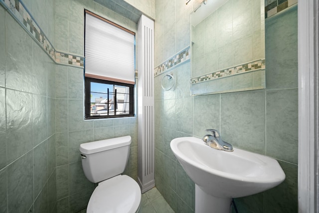 40-40 203rd St Unit 12B, Bayside, NY 11361 - bathroom with tile walls, toilet, a sink, and tile patterned flooring