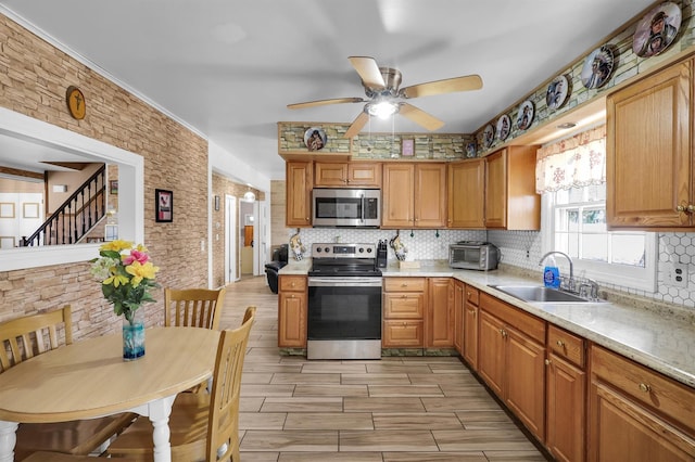 336 Auborn Ave, Shirley, NY 11967 - kitchen featuring appliances with stainless steel finishes, a sink, decorative backsplash, ceiling fan, and light countertops