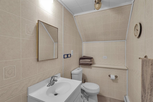 336 Auborn Ave, Shirley, NY 11967 - bathroom featuring tile walls, vanity, toilet, pet washing station, and a baseboard radiator