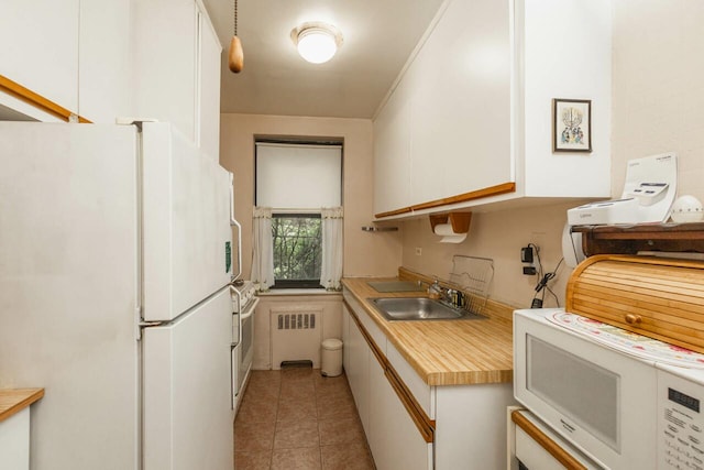 32-25 91st St Unit 209, East Elmhurst, NY 11369 - kitchen featuring white appliances, white cabinets, a sink, radiator heating unit, and light countertops