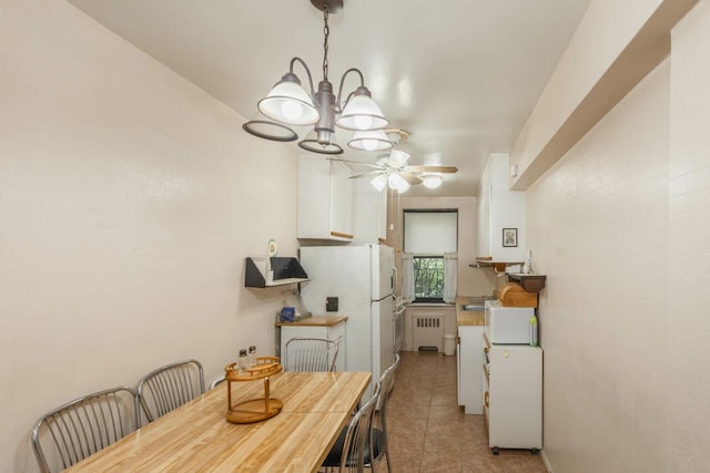 32-25 91st St Unit 209, East Elmhurst, NY 11369 - dining area featuring radiator heating unit, a chandelier, light tile patterned flooring, and a ceiling fan