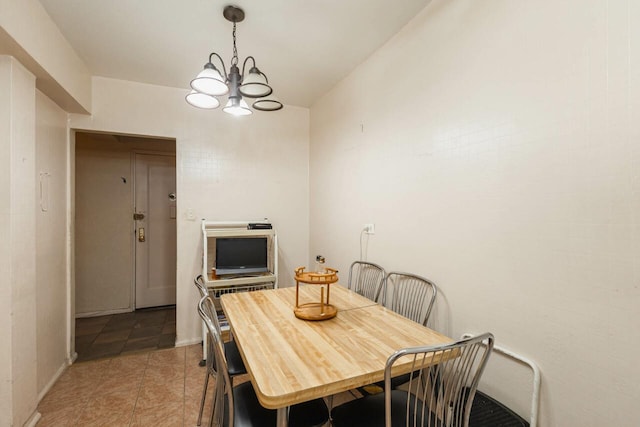 32-25 91st St Unit 209, East Elmhurst, NY 11369 - dining area featuring a chandelier, light tile patterned floors, and baseboards