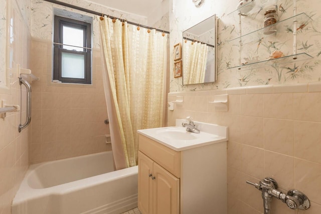 32-25 91st St Unit 209, East Elmhurst, NY 11369 - bathroom featuring wallpapered walls, vanity, shower / bath combination with curtain, a wainscoted wall, and tile walls