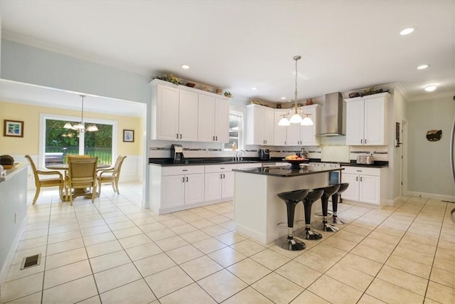 646 Rte 311, Patterson, NY 12563 - kitchen featuring wall chimney exhaust hood, a chandelier, ornamental molding, dark countertops, and tasteful backsplash