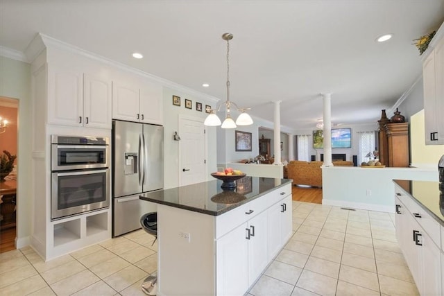 646 Rte 311, Patterson, NY 12563 - kitchen with stainless steel appliances, ornamental molding, light tile patterned floors, white cabinetry, and open floor plan
