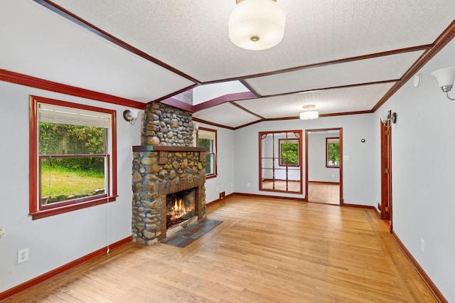 5 Murray Hill Rd, Sound Beach, NY 11789 - unfurnished living room with light wood-style flooring, plenty of natural light, a stone fireplace, baseboards, and ornamental molding