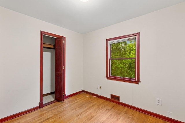 5 Murray Hill Rd, Sound Beach, NY 11789 - unfurnished bedroom with baseboards, light wood finished floors, and a closet