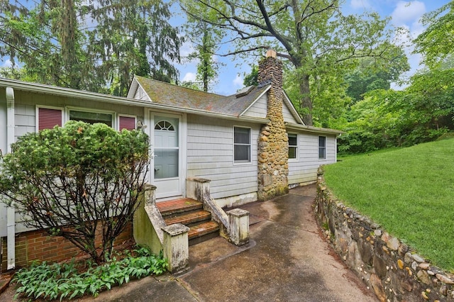 5 Murray Hill Rd, Sound Beach, NY 11789 - view of front of home with a front yard, a chimney, a patio, and a shingled roof