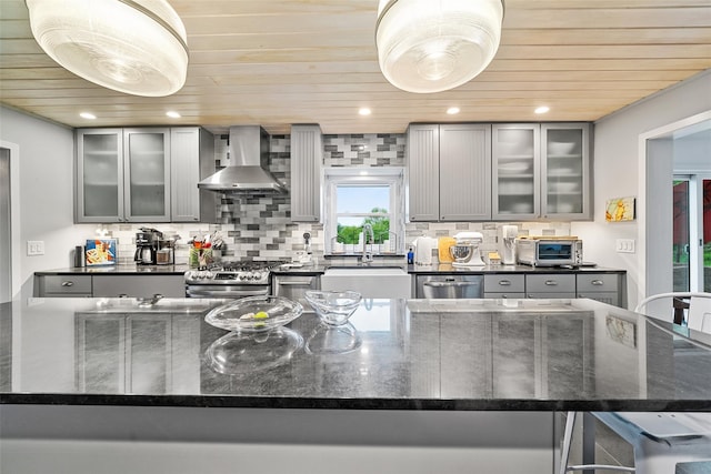 281 Hubert Rd, Jeffersonville, NY 12748 - kitchen with wall chimney range hood, wood ceiling, stainless steel appliances, gray cabinets, and a sink