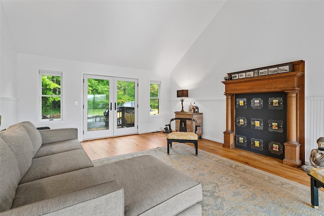 281 Hubert Rd, Jeffersonville, NY 12748 - living area featuring wood finished floors, french doors, high vaulted ceiling, and a wainscoted wall